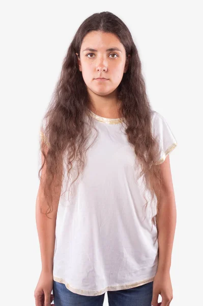 Caucasian teen girl with brown curly hair stands straight and looking at camera — Stock Photo, Image