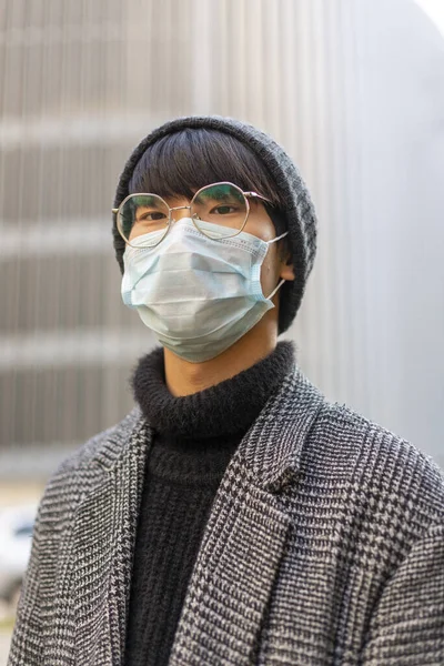 Asian young man. Chinese guy in medical mask against covid-19. Virus protection