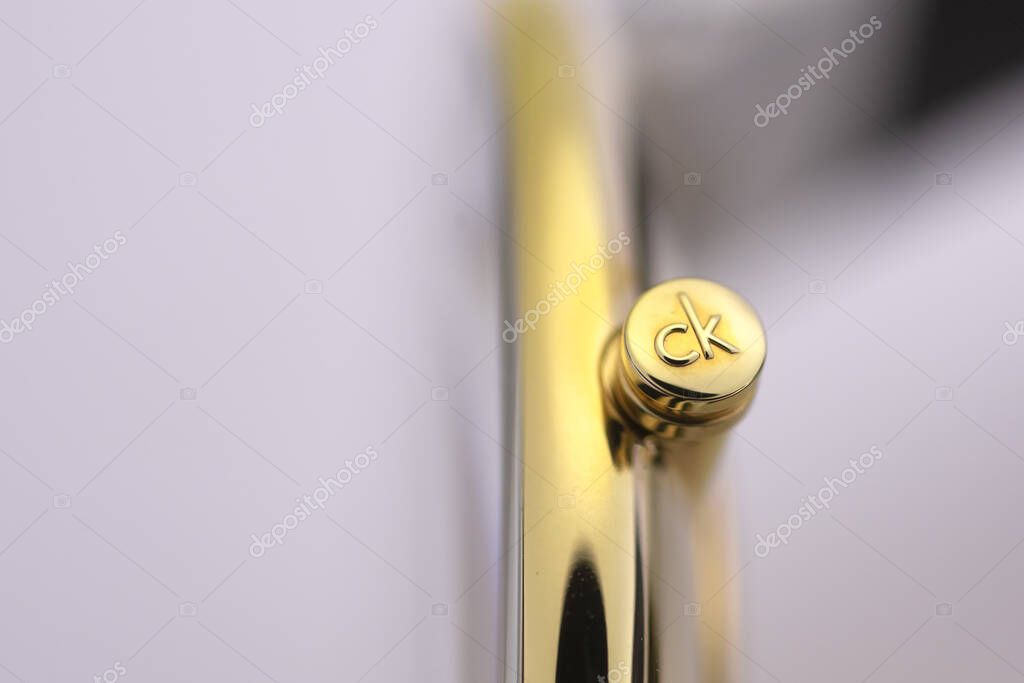 Biel, Switzerland 31.03.2020 - The closeup of CALVIN KLEIN woman watch stainless steel case gold PVD coating swiss quartz watch swiss made manufacture isolated macro .