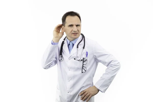 Middle-aged otolaringologist with hand on ear ignoring noise, hearing problems — Stock Photo, Image