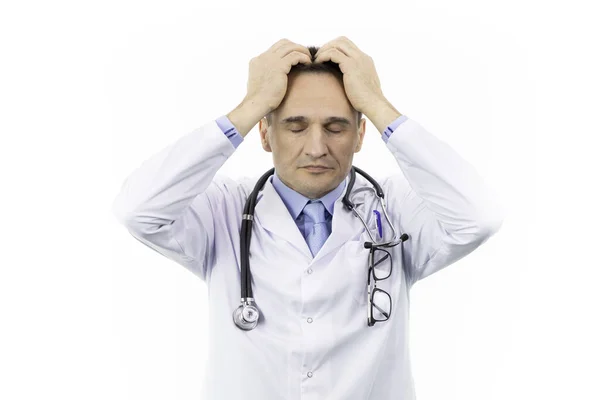 Handsome middle aged doctor in white medical gown with hand on head for headache — Stock Photo, Image