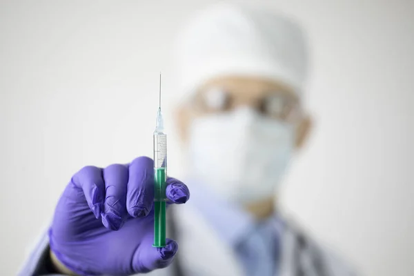 Lekarz trzymający strzykawkę ze szczepionką przeciwko koronawirusowi na białym tle — Zdjęcie stockowe