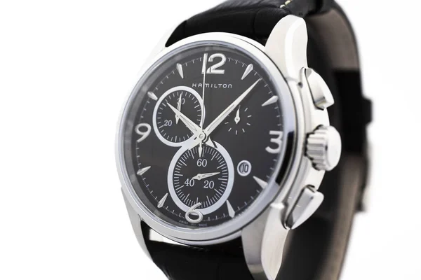Biel, Switzerland 31.03.2020 - The close of Hamilton man watch stainless steel case black clock face dial leather strap swiss quartz Machine watch isolated on stand swiss made manufactory — 스톡 사진