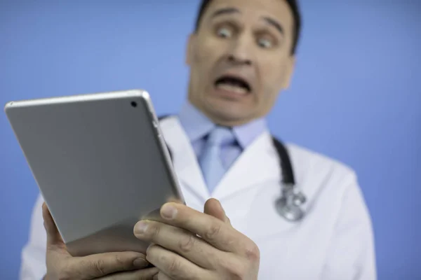 Diagnostic doctor looks at the tablet with the results of the patients tests
