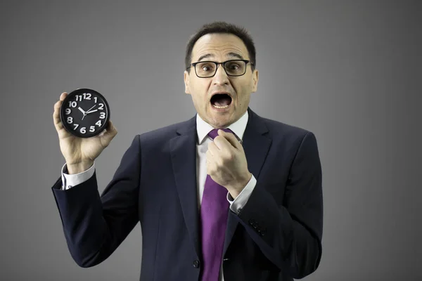 Stressed businessman with watch in hand. Man in panic, time management concept — Stock Photo, Image