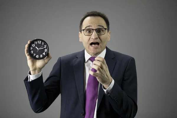 Stressed businessman with watch in hand. Man in panic, projects deadline concept — Stock Photo, Image