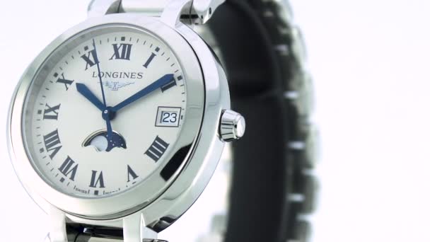 Saint-Imier, Switzerland, 2.02.2020 - Longines watch white clock face dial close up stainless steel bracelet. классические элегантные швейцарские часы — стоковое видео