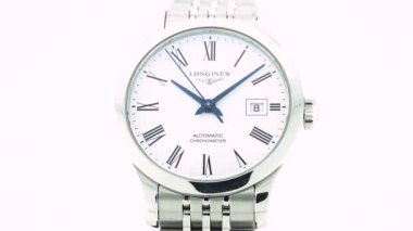 Saint-Imier, İsviçre, 2.02.2020 Longines beyaz saatin paslanmaz çelik bileziği çevirmesini izliyor. Klasik İsviçre yapımı saatler.