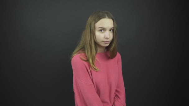 Blyg dam i lös rosa pullover står under elektriskt ljus — Stockvideo