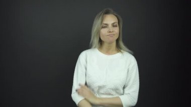 Şüpheli sarışın kadın gizemli bir gülümsemeyle dümdüz görünüyor.