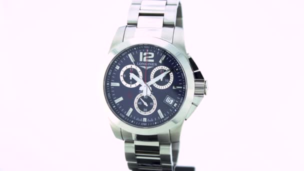 Saint-Imier, Switzerland, 2.02.2020 - Longines watch black clock face dial stainless steel bracelet. модные современные швейцарские часы — стоковое видео