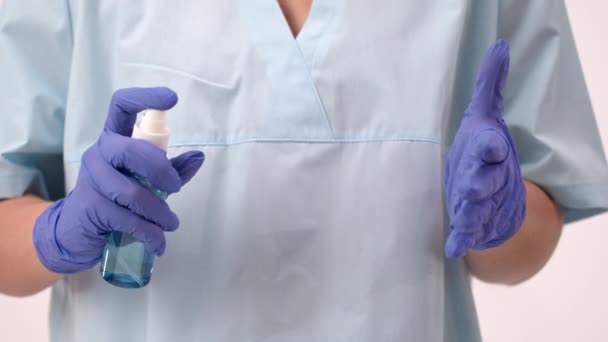 Hospital worker in medical gloves wash hands with antibacterial sanitizer spray — Stock Video