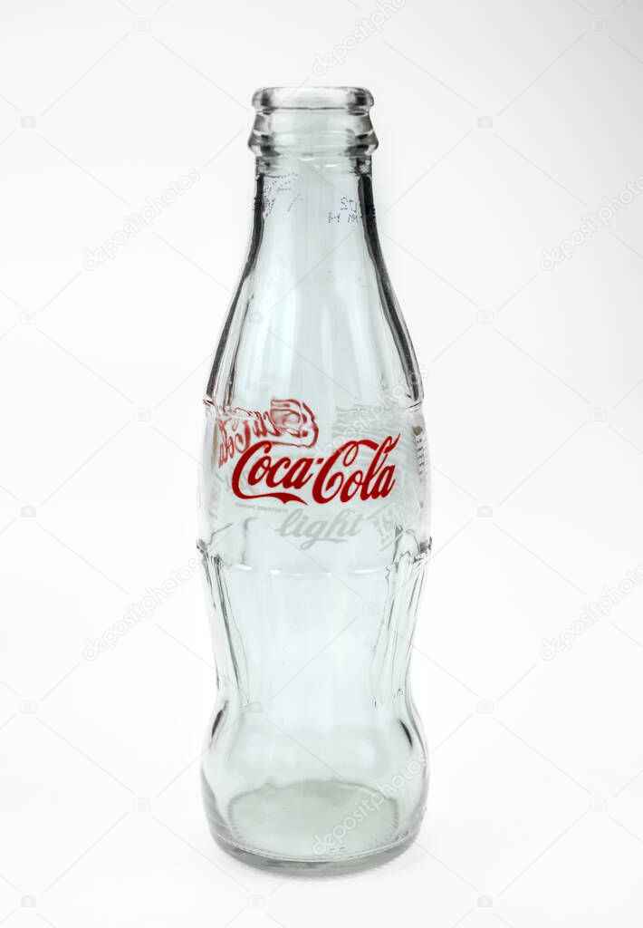 Atlanta, Georgia, USA April 1, 2020: empty classic contour glass bottle of Coca Cola Light from USA closeup . concept of globalism, global brand, worldwide spread isolated on white background