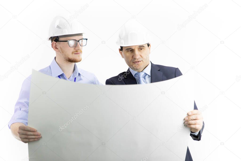 Two positive engineers look at drawing, boss gives instructions to subordinate