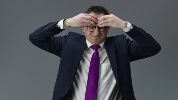 Tired and puzzled businessman suffers from headache rubbing forehead with hands — Stock Video
