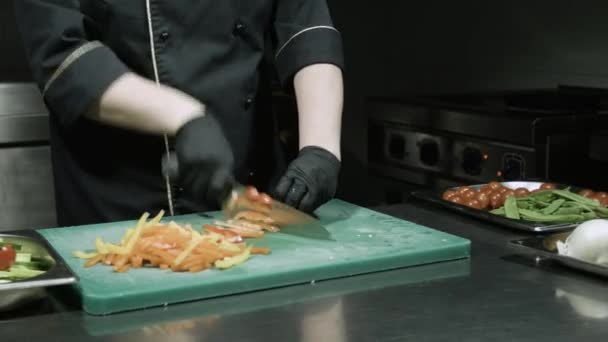 Cocina las manos en guantes negros rebanando pimientos — Vídeos de Stock