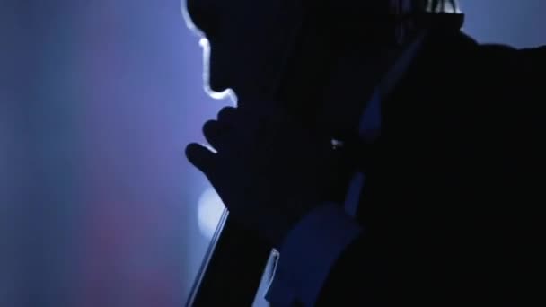 Musiker spielt Cello in Nahaufnahme Bogen und Saiten schwarz beleuchtet — Stockvideo