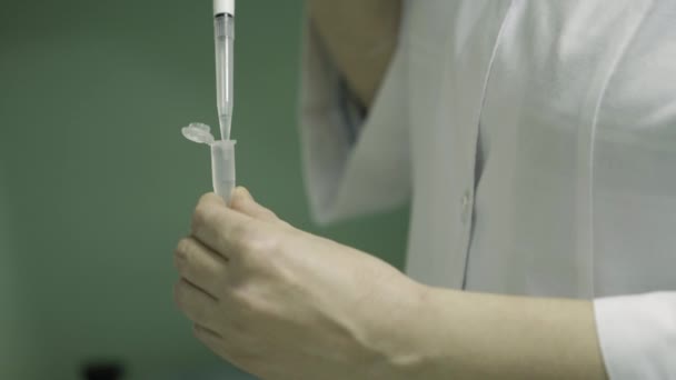 The operator measuring a sample of water or solution in a chemical laboratory in a medical solution factory. close up — Stock Video