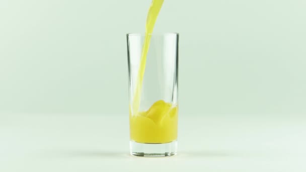 Juice pouring into glass isolated on white background — Stock Video