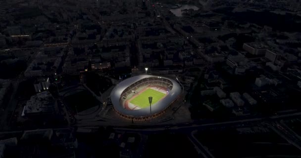 Minsk, Belarus - Oktober, 2019: floodlit Dynamo Minsk stadium at sunset during a football match drone shot. Champions League and Europa League matches are being played. — Stock Video