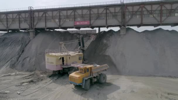 Mikashevichi, Belarus, 14.04.2020 - Heavy mining equipment excavators, large dump trucks, front loaders working on production of crushed stone, drone shot aerial view slow motion — 图库视频影像