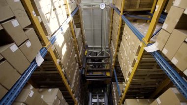 Forklift karton kutularla dolu paletleri taşır.