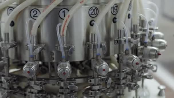 Glass bottles on a medical solution conveyor at filling station close up — Stock Video