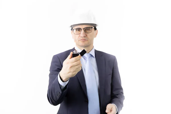 Serious drilling oil engineer holds burning lighter confidently looks at camera — Stock Photo, Image