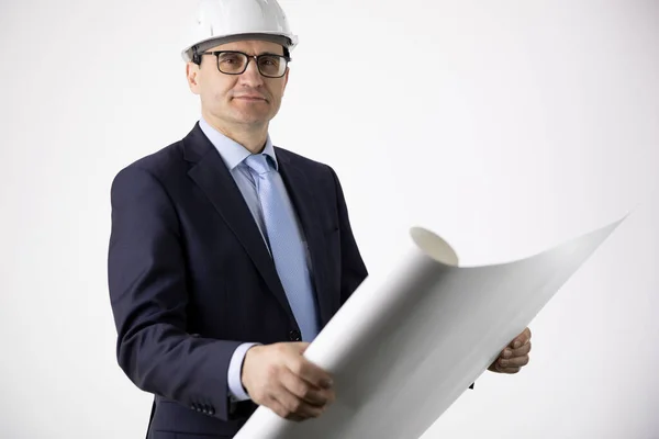 Architect bouwer in beschermende helm holding lay-out plan blauwdruk — Stockfoto