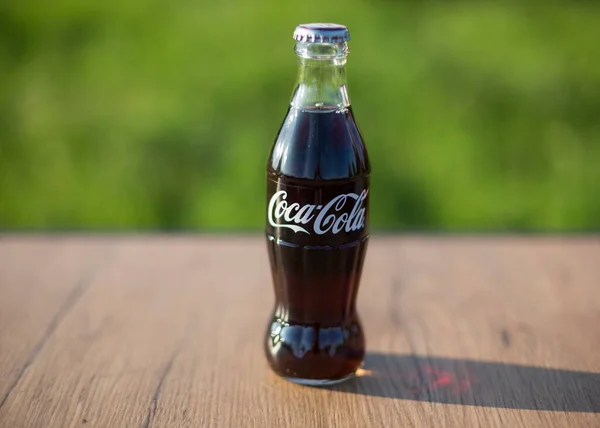 Atlanta USA May 1 2020 classic glass Coca Cola Bottle on wooden table outdoors — Stock Photo, Image