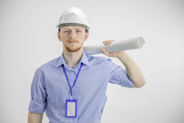 Handsome engineer in hard hat holding blueprint roll on shoulder successful man — Stock Photo, Image