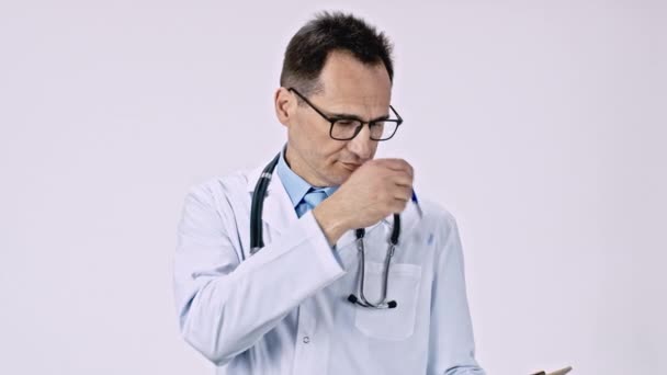 Kaukasischer Arzt holt Stift aus Brusttasche und macht Notizen auf dem Tablet. — Stockvideo