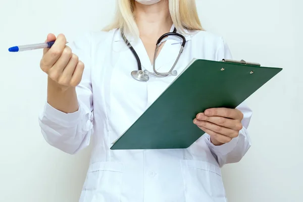 Mulher médica escrevendo na área de transferência um diagnóstico e prescrição após o exame de um paciente — Fotografia de Stock