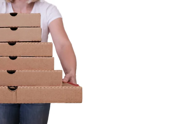 Woman holding many pizza boxes of different sizes, white background, copy space.