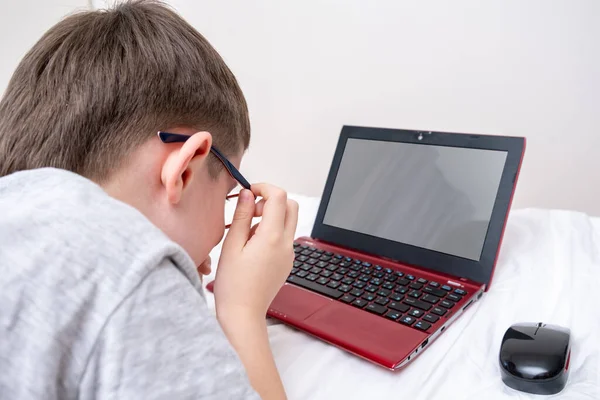 Niño Acostado Cama Con Una Computadora Portátil Distancia Aprendizaje Electrónico —  Fotos de Stock