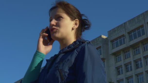 Una mujer hablando por teléfono en la calle. cámara lenta, 120 fps — Vídeo de stock