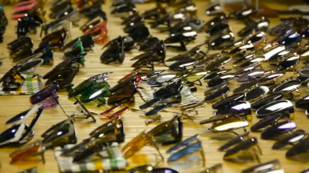 Collection of sunglasses on the counter, Large selection of sunglasses — Stock Video