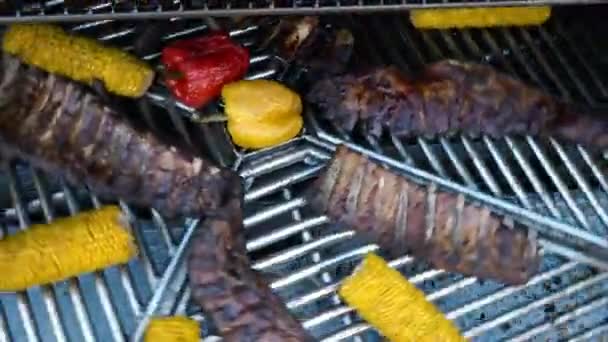 Lamb Ribs and Vegetables on a Rotating Grill, meat and corn on a barbecue, 4K — Stock Video