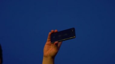Hayranlar akıllı telefonlardan video kaydediyor. Canlı yayın. Hikayeler. Kalabalık bir konser izliyor, şarkı söylüyor, zıplıyor. Çarpıcı sahne ışıkları. Mutlu insanlar inanılmaz bir konser izliyorlar.