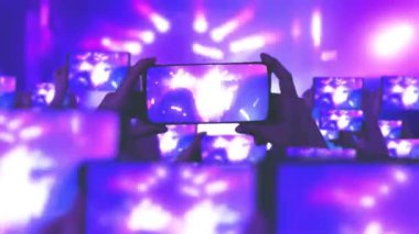 Kalabalık bir konser izliyor, şarkı söylüyor, zıplıyor. Konser sırasında havada yüzen altın konfetileri. Hayranlar akıllı telefonlardan video kaydediyor. Bir sürü akıllı telefon. Canlı yayın. Hikayeler. Sahne ışığı.