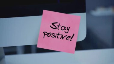 Olumlu düşün. Yapışkan notlar. Monitördeki çıkartmadaki yazı. Mesaj var. Motivasyon. Hatırlatma. İş yerindeki hayat felsefesi. El yazısı bir kalemle yazılmış. Renk etiketi. 