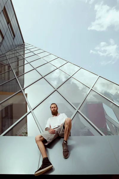 Sakallı dövmeli hipster ofis binası önünde
