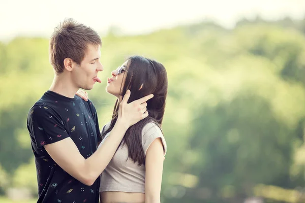Happy young couple on natural green blurry background — Stock Photo, Image