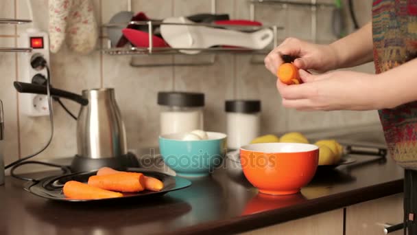 Cleaning boiled carrot in the kitchen — Stock Video