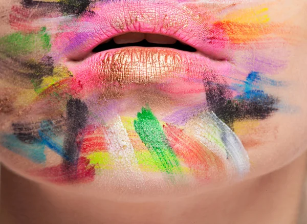 Lips in close up photo with colors on face — Stock Photo, Image
