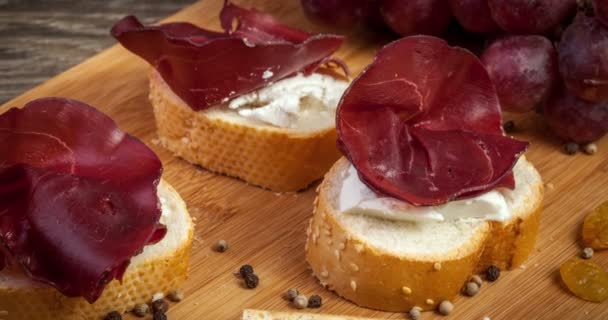 Delicious italian ham on wooden background — Stock Video