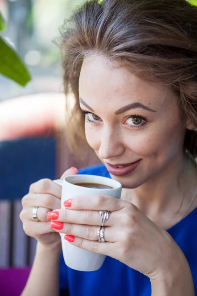 Beautiful woman drinking a cup of coffee