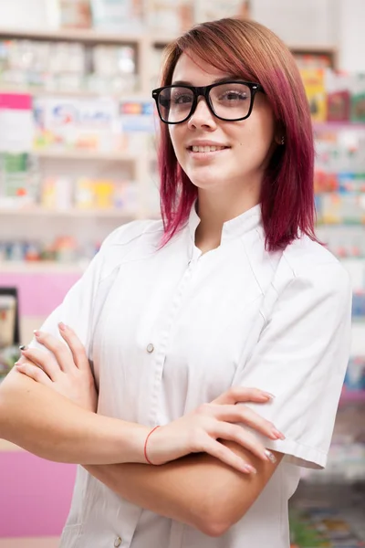 Redhead pharmacist in front of her desk — Stock Photo, Image