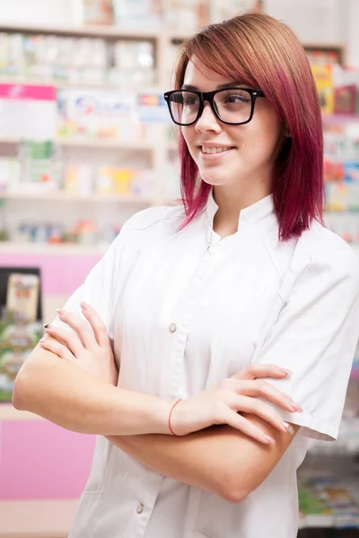 Redhead pharmacist in front of her desk — Stock Photo, Image