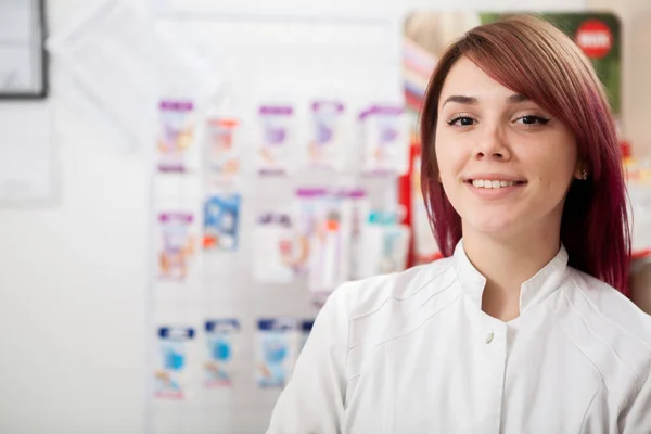 Beautiful pharmacist in front of her desk — Stock Photo, Image